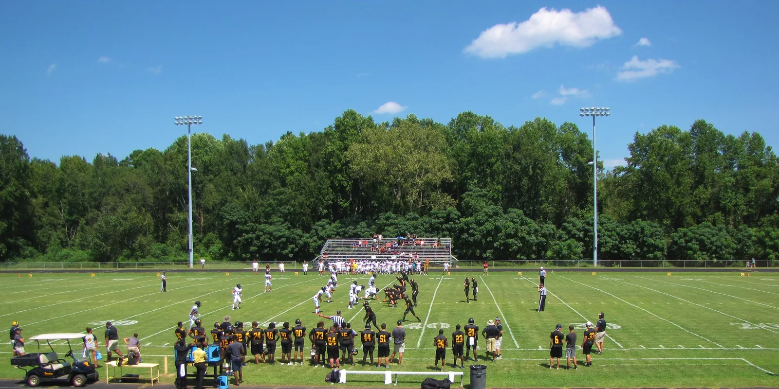 Players line up for a snap at a public high school football game in Fairmont, North Carolina