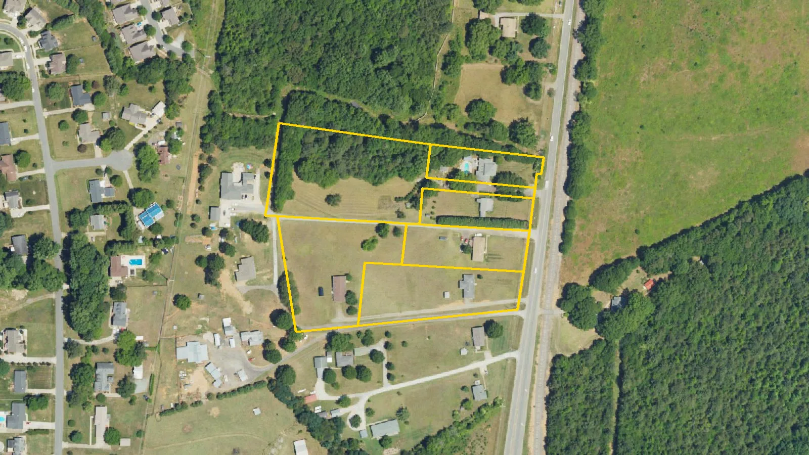 The six parcels on Old Statesville Road (N.C. 115) that make up the Northline Row site, outlined in yellow on a federal aerial photo. The picture does not show the site as it is today.