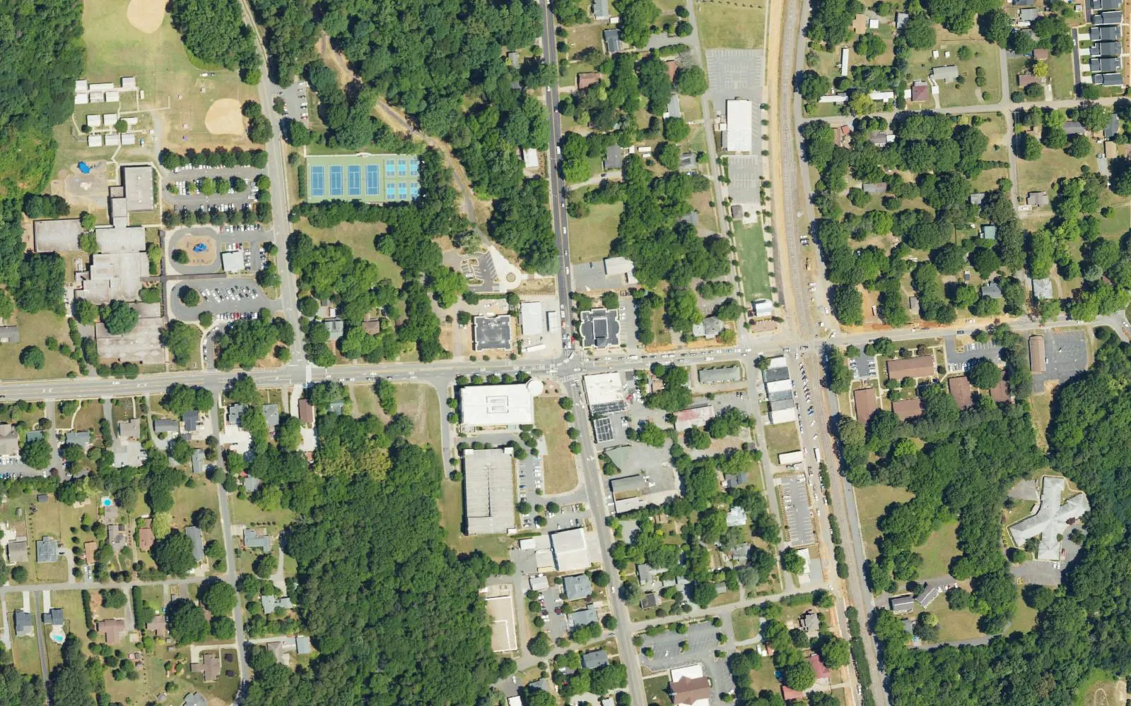 Downtown Huntersville from the air, centered on Gilead Road and Old Statesville Road (N.C. 115), with Huntersville Elementary at left and the railroad at right
