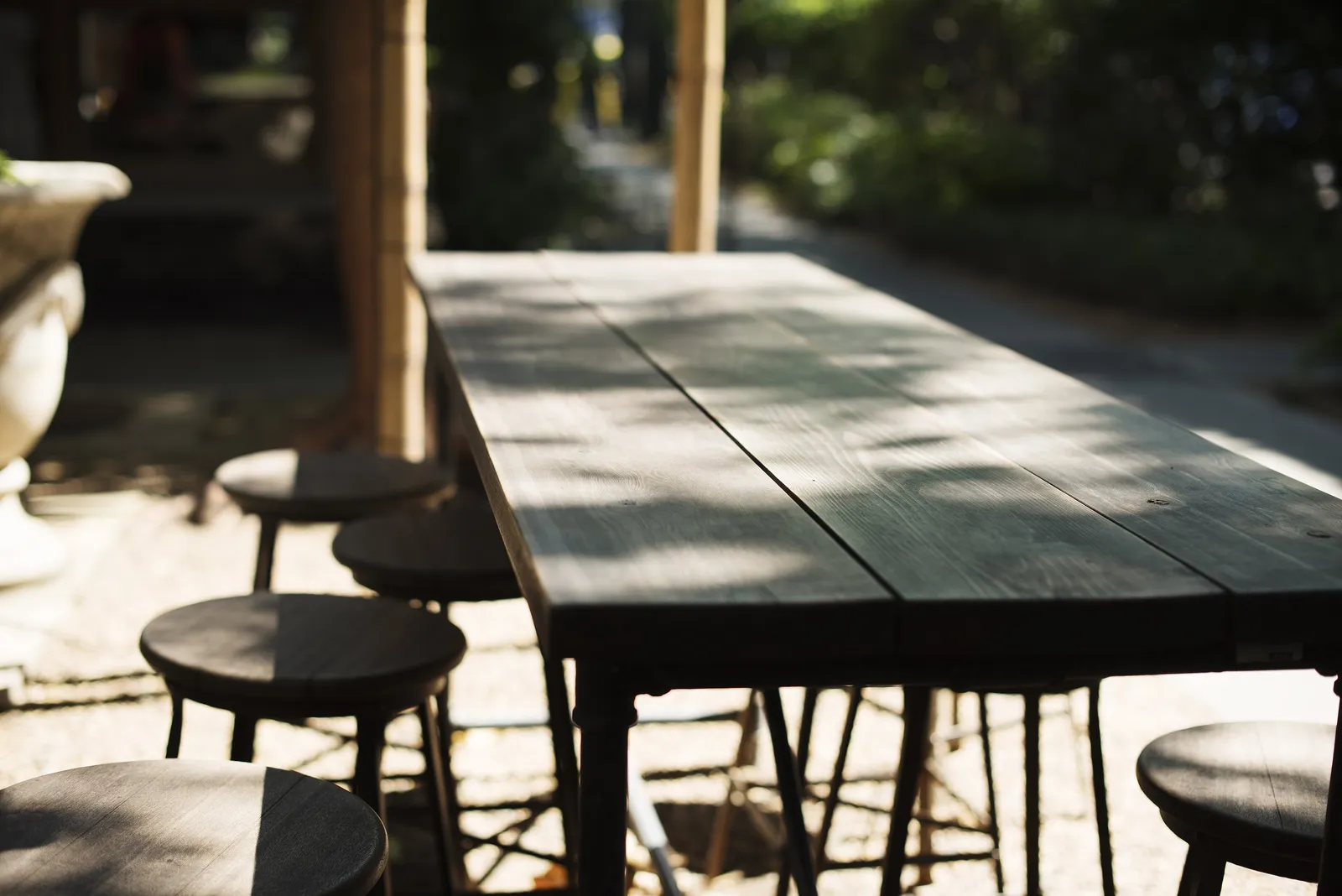 Outdoor tables and stools at a restaurant patio; the photo does not show a Huntersville restaurant.