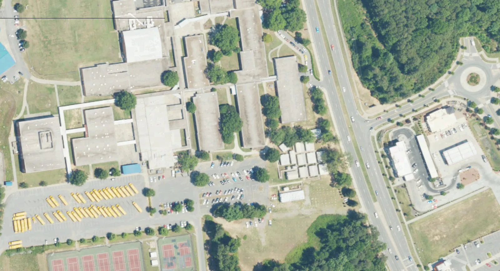 North Mecklenburg High School's classroom wings and parking lots beside Old Statesville Road (N.C. 115) in Huntersville, seen from the air