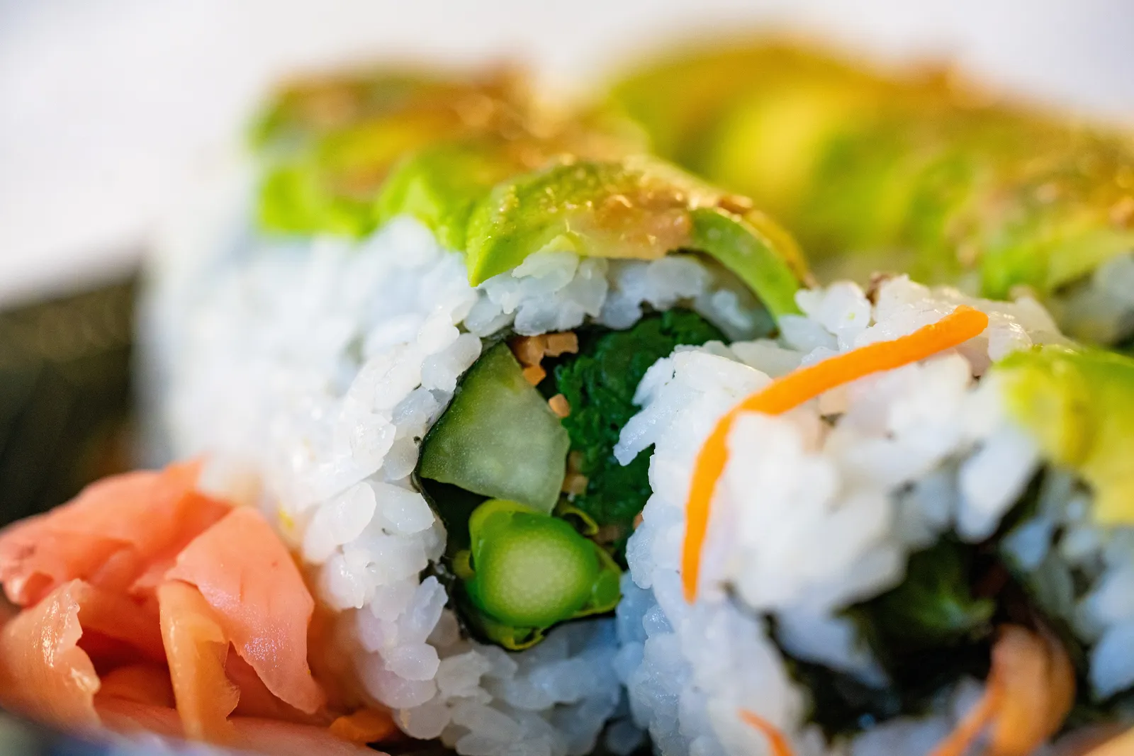 Vegetable sushi rolls with avocado and pickled ginger; the photo does not show a Huntersville restaurant.
