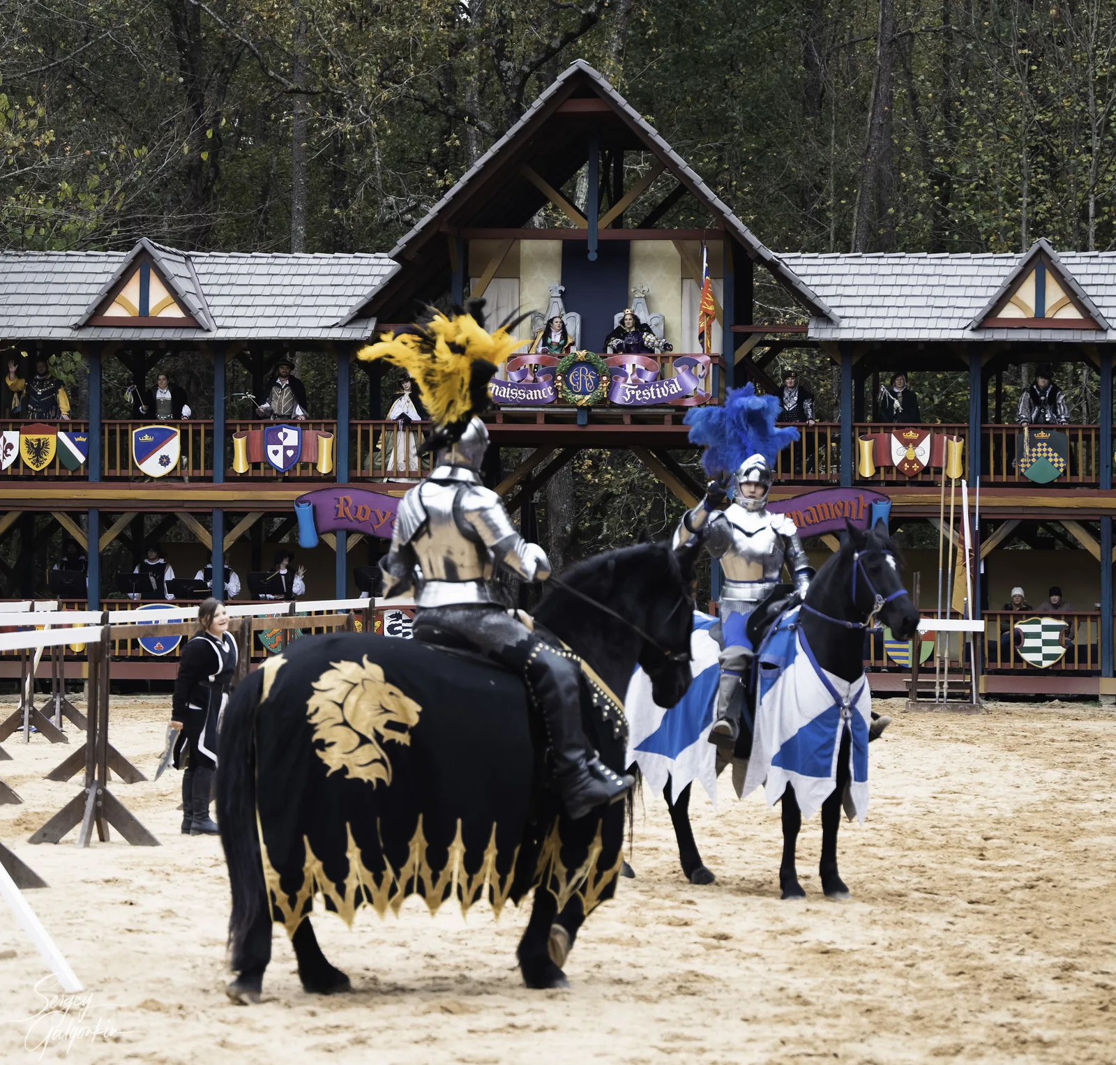 Two armored knights on horseback in the jousting arena at the Carolina Renaissance Festival in Huntersville