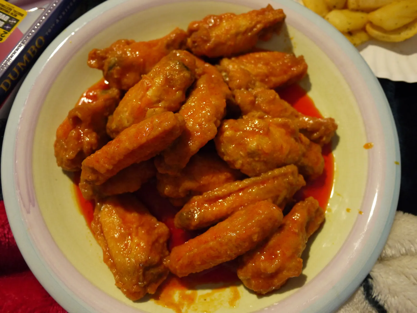 A plate of Buffalo wings with sauce; the photo does not show a Huntersville restaurant.